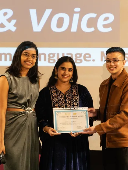 Celebrating a milestone. A participant receives her certificate of completion at the 'Verse & Voice' performance showcase. We believe in recognizing your hard work and providing credentials that strengthen your creative resume.