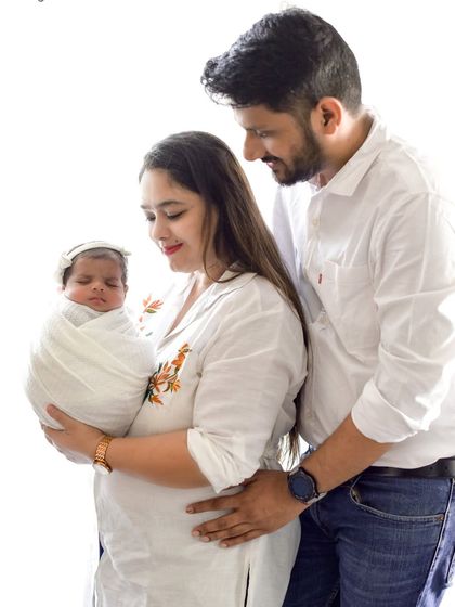 A classic family pose with the new baby. I guide families into positions that are comfortable and that naturally show their love and connection.