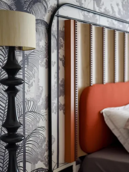 Another detail shot of the headboard and custom floor lamp. The combination of different textures and materials creates a rich and layered design.