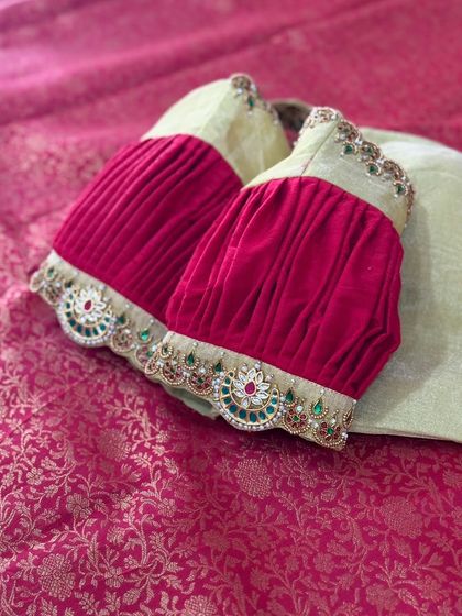 A unique blouse with pleated velvet sleeves and an embroidered cuff.