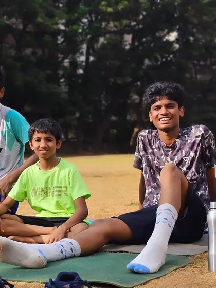 Young players relaxing after an outdoor conditioning session, enjoying the camaraderie that comes with training together.