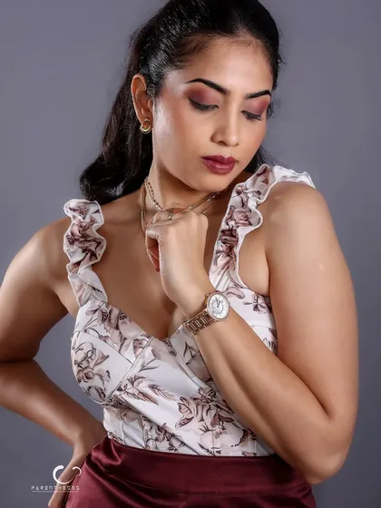 An elegant, downward glance. This pose, combined with the soft studio lighting, creates a classic and sophisticated portrait that feels both personal and timeless.
