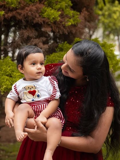 A sweet moment between mother and child in a park. Her loving gaze and his adorable expression make this a perfect candid portrait.