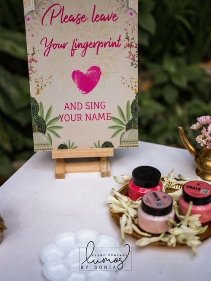 A close-up of the fingerprint station, with colorful inks and a beautifully designed sign.