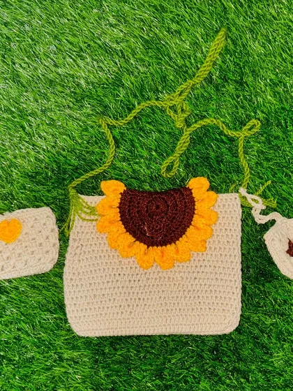 My signature crochet sunflower sling bag set. This three-piece combo includes the main bag, a matching small pouch, and a tiny charm, all handcrafted with durable yarn.