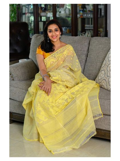 Another relaxed pose, perfect for showing how the saree can be worn comfortably at home.