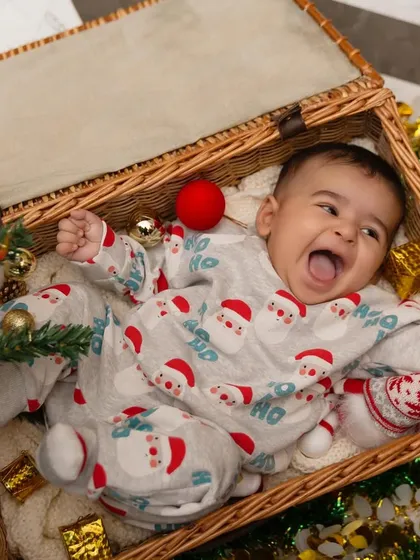 The pure joy of Christmas, captured in a basket of festive cheer. This little one's excited expression is what the holiday season is all about.