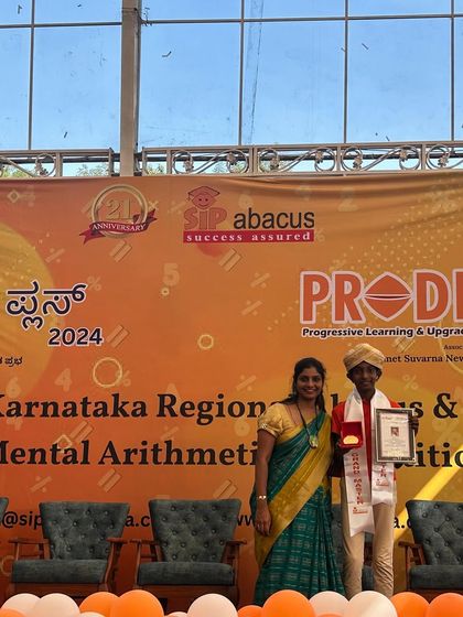 A proud student receives his graduation award. Each certificate represents hours of practice, improved focus, and a newfound love for numbers.