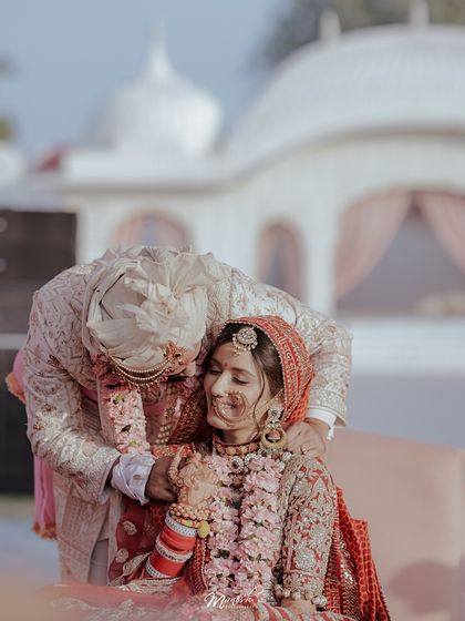 A tender moment post-ceremony, the groom's gentle touch conveying love and care for his new bride.