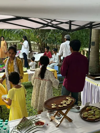 A wider view of the kids' party brunch. You can see guests of all ages enjoying the food in a relaxed, beautiful garden setting. I create an atmosphere, not just a menu.