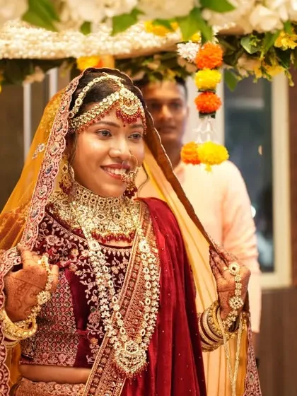 The bride's grand entrance under a phoolon ki chadar, a classic and beautiful moment in Indian weddings.
