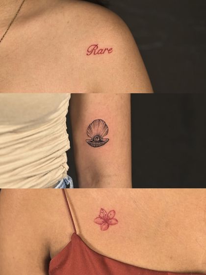 A collection of small, delicate tattoos for a group of friends, including single-word tattoos in red ink, a tiny pearl in a shell, and a small flower.