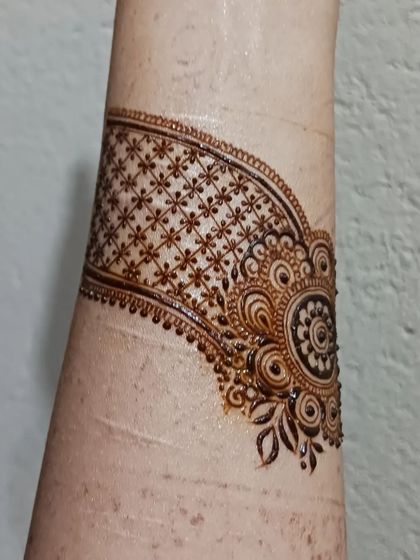 A practice doodle of a cuff design. I often practice creating bands and bracelets with different textures, like this one with a delicate grid and floral motif.