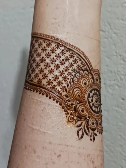 A practice doodle of a cuff design. I often practice creating bands and bracelets with different textures, like this one with a delicate grid and floral motif.
