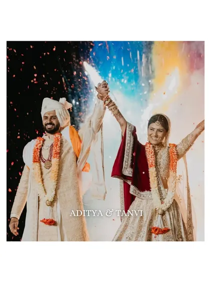 The moment of union, bursting with color and energy. We love capturing the peak of the celebration, like this vibrant varmala moment, where joy is so palpable you can almost feel the confetti and hear the cheers.