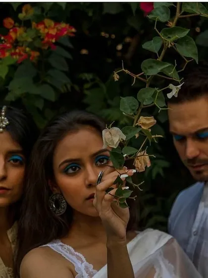 A group portrait for a conceptual shoot with a focus on bold, matching blue eyeliner on all models. This creates a strong, unified visual theme for the editorial story.