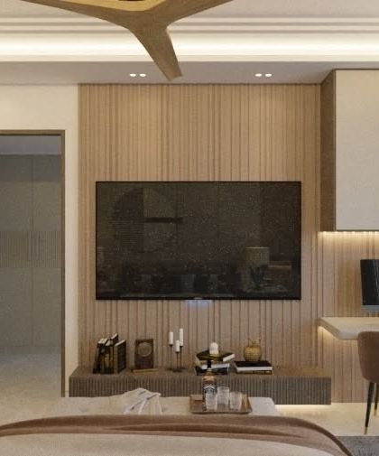 A bedroom concept featuring a functional TV wall with an integrated study desk and open shelving. The use of wood paneling and a neutral color palette creates a warm and modern aesthetic.