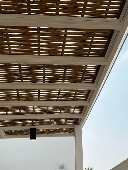 The beauty is in the details. This is a close-up of our handmade woven bamboo pergola, which provides beautiful, dappled shade and adds a unique, natural texture to your outdoor space.