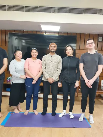 An instructor with students from the March-April international batch. We are dedicated to guiding each student on their unique yoga journey.