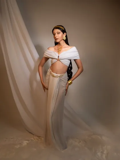 Another look from the Grecian-inspired shoot, this time featuring a different draping style and a braided hairstyle. The image showcases versatility in styling within a single conceptual theme.