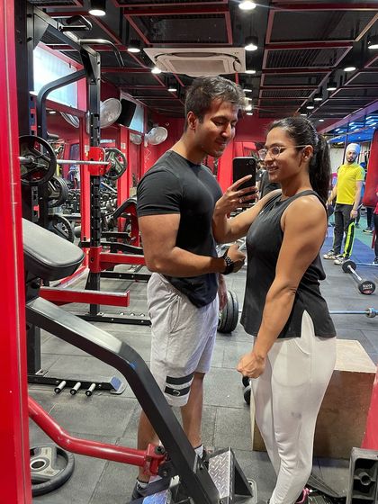 A candid moment at the gym with my partner. We push and motivate each other to be our best.