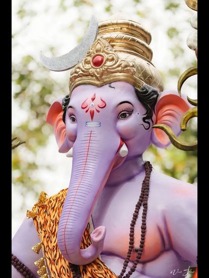 A detailed portrait of the Kopri Cha Samrat, focusing on the calm and serene expression of the idol.