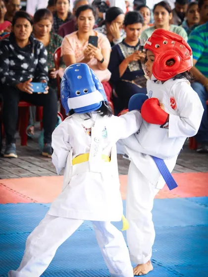 An action shot from a Kumite match, showing a student executing a controlled kick. These events teach valuable lessons in timing, strategy, and respect for one's opponent.