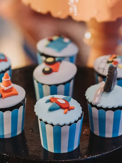Themed cupcakes with fondant toppers of airplanes, traffic cones, and tires. Even the smallest treats are part of the story.