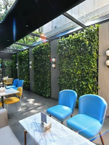 We revamped the lounges at Smoor Chocolates with these dense living walls. The project demonstrates how interior landscaping can enhance a commercial space, creating an inviting and refreshing atmosphere for customers to enjoy.