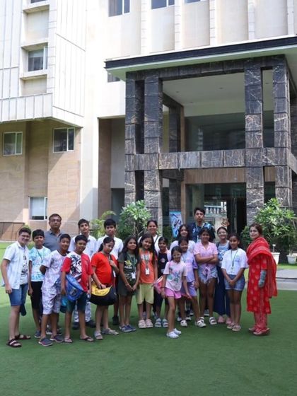 A group of participants poses for a photo in front of our school building during the 'Nautica' aquatic meet. These events are not just about competition but also about building camaraderie and making new friends.
