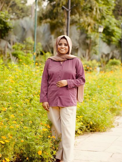 Standing in a field of flowers, feeling grateful for my journey. My goal is to help every woman feel this confident and happy in her own skin.