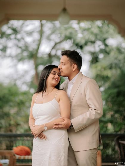 A tender moment in a beautiful verandah in Varanasi, where the groom gently kisses the bride's forehead.