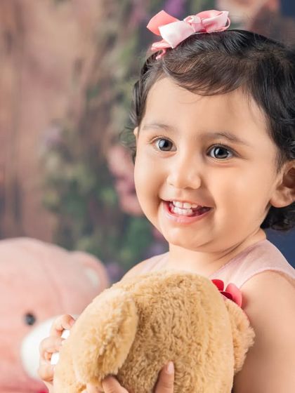 This little girl is sharing a hug with her best teddy bear friend. A truly sweet and classic portrait.