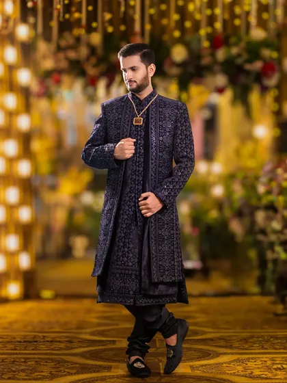 The groom's style deserves its own spotlight. This is a classic groom portrait, showcasing his sharp attire and confident presence against a beautifully lit, elegant backdrop before the main event.