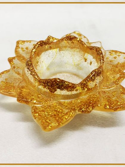 A beautiful lotus-shaped tea light holder made from glitter-infused resin, a popular project in our decorative craft workshops.