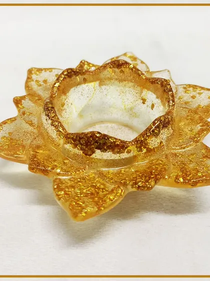 A beautiful lotus-shaped tea light holder made from glitter-infused resin, a popular project in our decorative craft workshops.