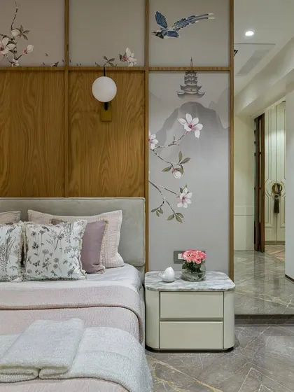 This bedroom is a testament to refined elegance, where a custom Chinoiserie wallpaper creates a symphony of subdued hues and delicate detailing. The design, integrated with wood paneling, sets a tone of tranquility and artistic sophistication, perfect for a personal retreat.