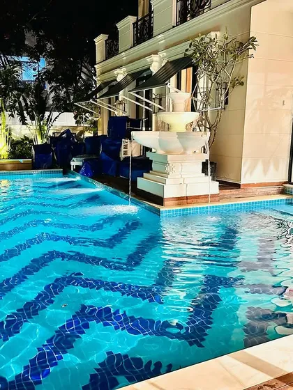 This residential pool showcases our expertise in creating luxurious and unique water features. We handled the complete execution, including the custom chevron tile pattern, integrated multi-tier fountain, and ambient underwater lighting for a stunning nighttime effect.