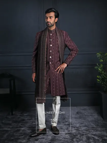 In the richness of wine tones and the grace of pintucked textures lies an Achkan that speaks of heritage, a seamless blend of tradition and contemporary minimalism.