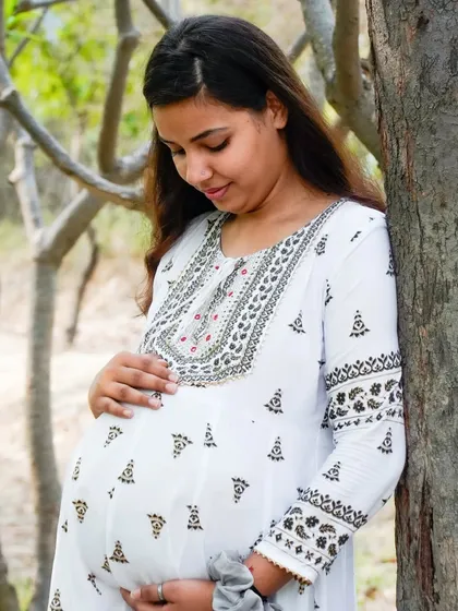 A gentle and serene portrait of a mother-to-be. We work to make you feel comfortable and beautiful during your maternity photography session.