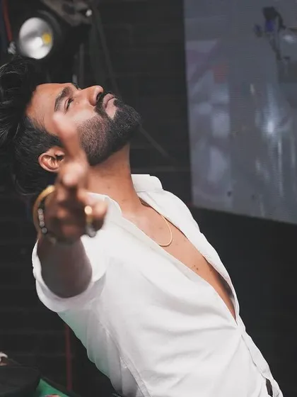 A stylish pose during a set at Freq Club. The look is part of the performance.