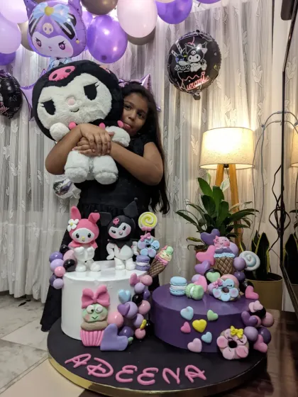 My daughter hugging her new Kuromi plushie, with the matching cake I made for her right beside it. Her happiness is my greatest inspiration.