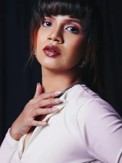 A classic portrait pose that exudes elegance. The lighting is soft and flattering, creating a timeless look.