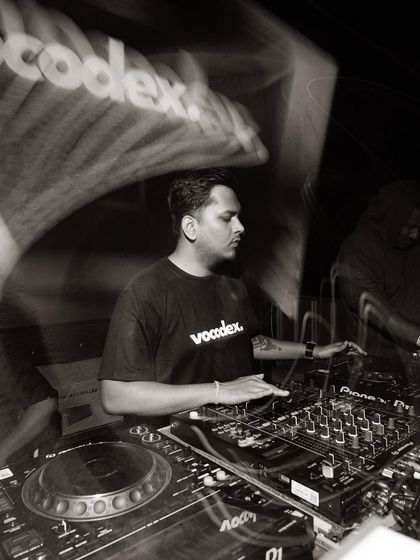 Another angle from my "Homework" series. This black and white photo highlights the intricate details of the DJ mixer and my hands at work.