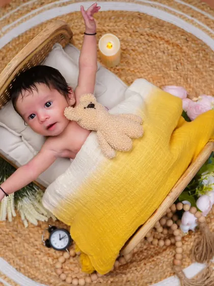 Reaching out to the world! This action shot captures the natural movements and stretches of a newborn.