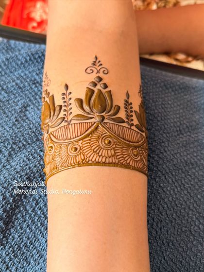 The start of a beautiful bridal design, with a lotus cuff on the forearm.