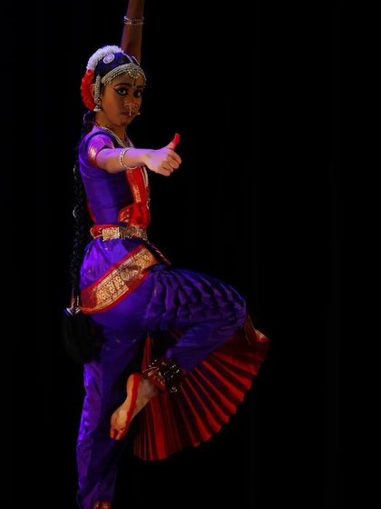 This dynamic pose, captured during Sahana's Arangetram, showcases the strength and precision required in classical dance, a result of years of patient practice.