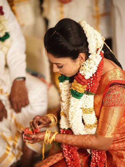 A candid shot of the bride during her wedding rituals. The makeup is designed to stay put, ensuring she looks perfect throughout the ceremony.