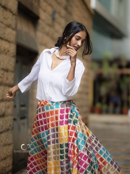 Capturing movement and grace in an urban alley. The swirl of her colorful skirt against the stone wall creates a beautiful contrast, telling a story of vibrant life in the city.