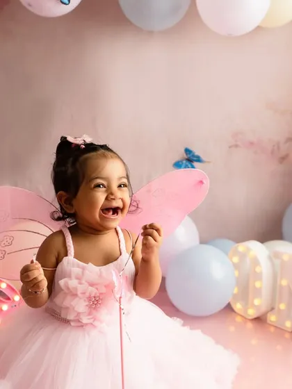 Capturing the pure, uninhibited joy of a first birthday cake smash. This butterfly themed session was designed to be fun and memorable, resulting in genuine laughter and beautiful photographs that celebrate this special milestone.